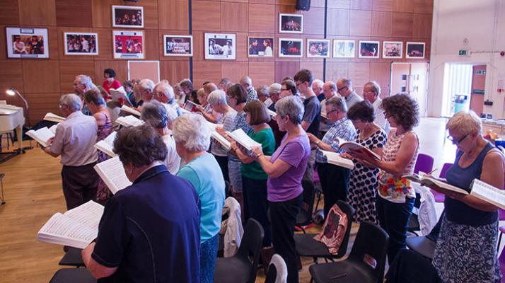 members of chorus sing during rehearsals
