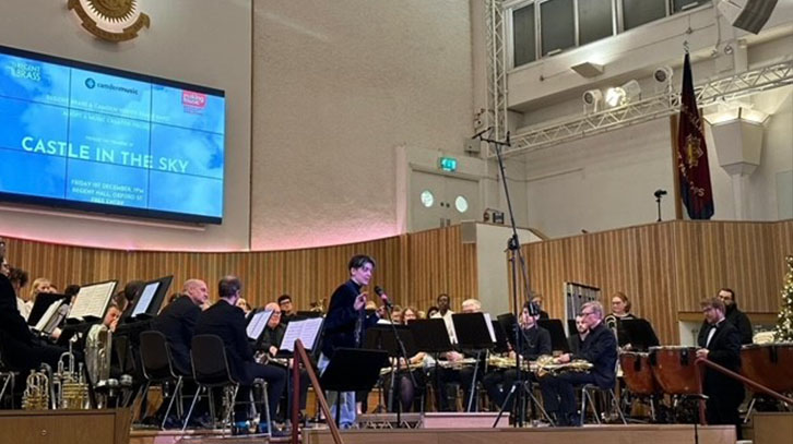 the composer talking on stage before the concert