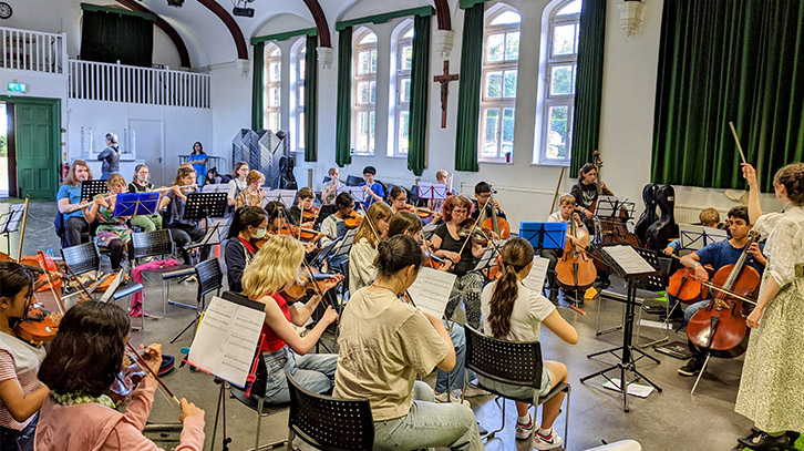 students sitting down with their instruments during the workshop