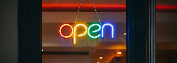 'open' sign in the window, multi coloured lettering