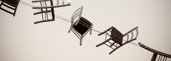 A line of chairs suspended from wires