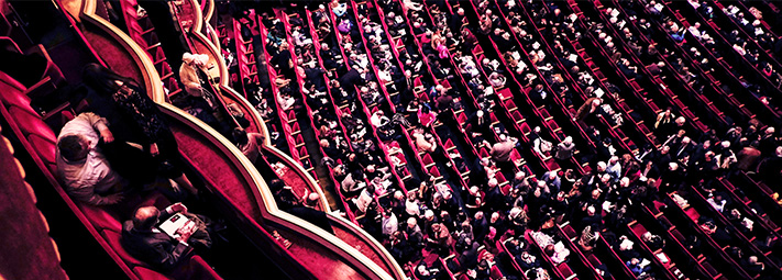 red concert hall full with patrons