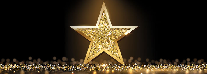 Gold five point star on a dark background