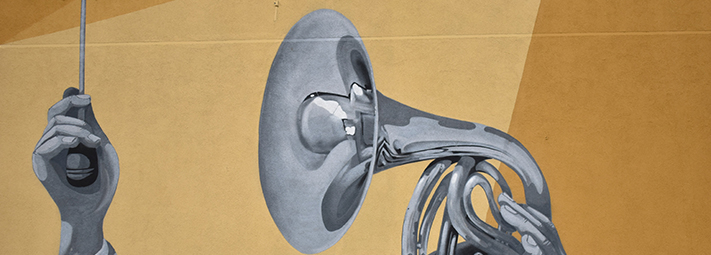 grey hand and brass instrument