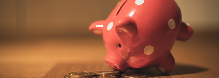 pink piggy bank with coins