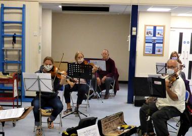 Alton Concert Orchestra members wear face coverings during a socially-distanced, COVID-secure rehearsal