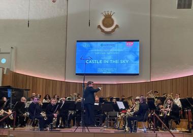 Brass band performing music called Castle in the Sky in concert hall