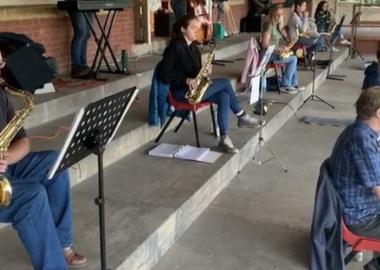 swing band rehearse with social distancing outdoors