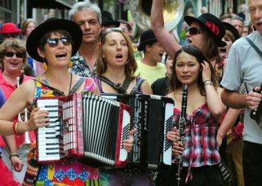 Musicians playing various instruments during an outdoor parade
