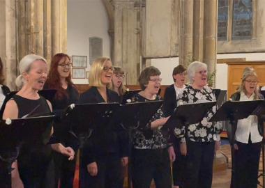 members of the northern rose voices performing in a church