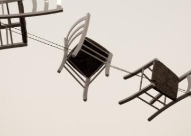 wooden chairs flying through the air