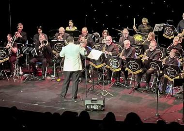 Photo of Belvoir Big Band performing with conductor and two singers.