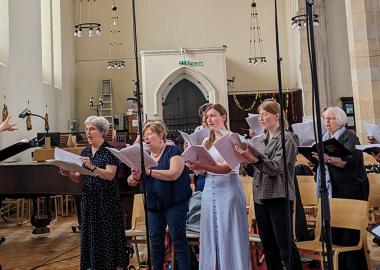 people standing up in a church and singing