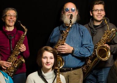 Aberdeenshire Saxophone Orchestra members pose with different types of saxophone