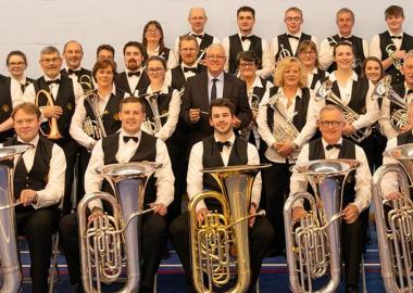 members of City of Bristol Brass Band sitting in group with their instruments