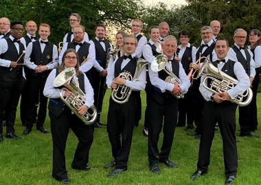 City of Bristol Brass Band pose in tuxes with their instruments