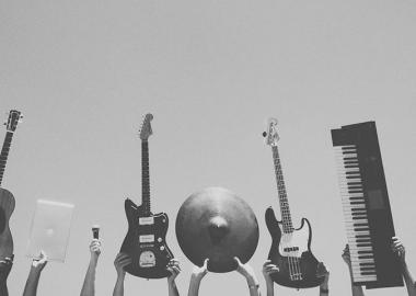 people holding up variety of instruments