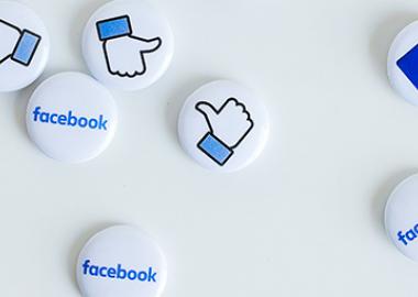 Blue Facebook logos and thumbs up printed on badges