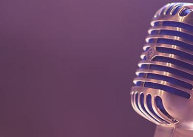 silver microphone on a purple background