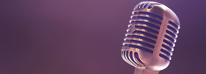 Purple background with old school microphone